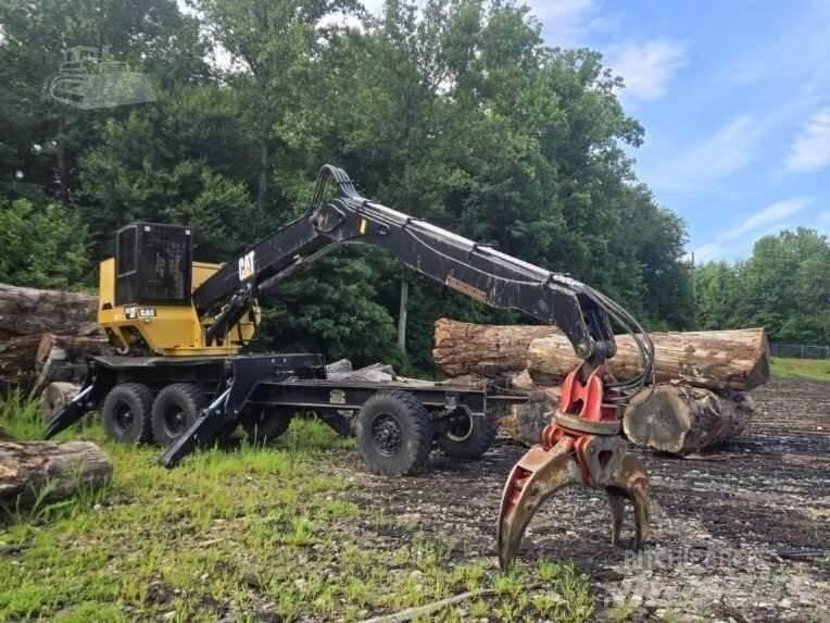 CAT 559C Boomstamladers